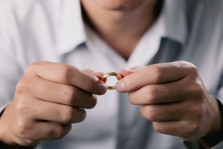 man taking off wedding ring