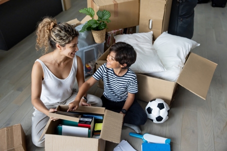 mother and child packing moving boxes