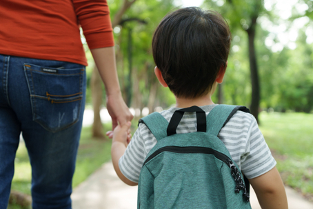 child holding parent's hand
